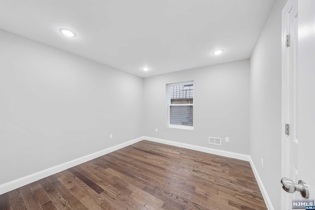 unfurnished room featuring dark hardwood / wood-style flooring