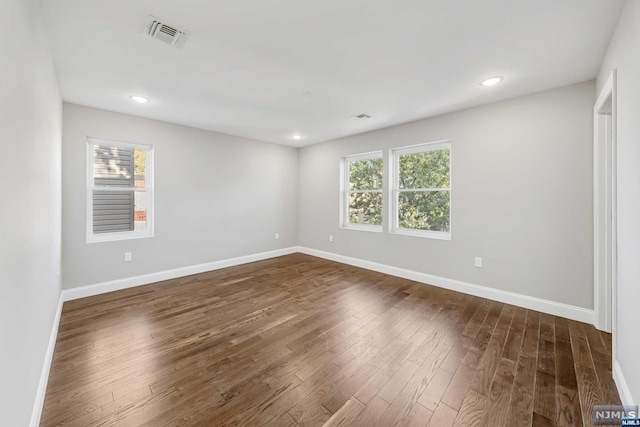 spare room featuring dark hardwood / wood-style floors