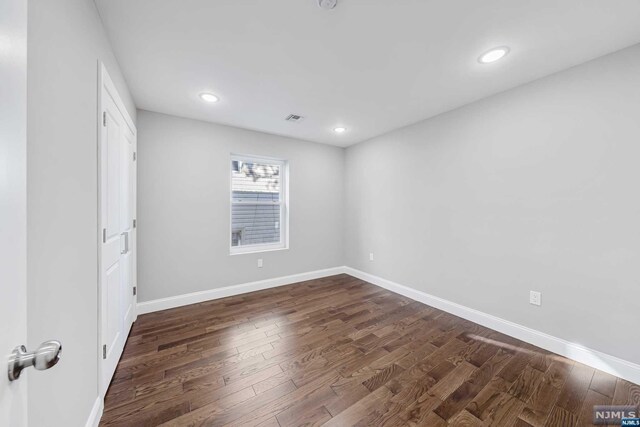 empty room featuring dark wood-type flooring