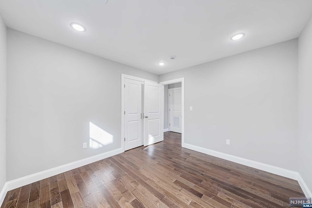 unfurnished room with hardwood / wood-style floors