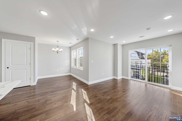 interior space featuring a chandelier and dark wood-type flooring