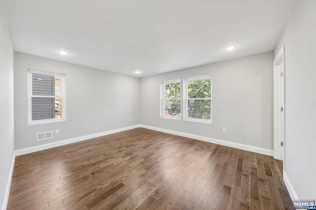 spare room with dark hardwood / wood-style flooring