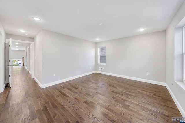 empty room with dark hardwood / wood-style floors