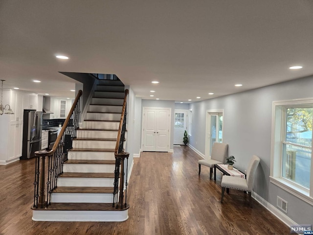 stairs featuring hardwood / wood-style floors