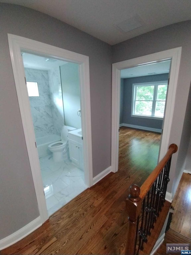 corridor featuring dark hardwood / wood-style floors