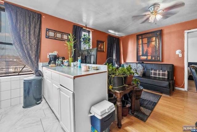 interior space with light hardwood / wood-style flooring and ceiling fan