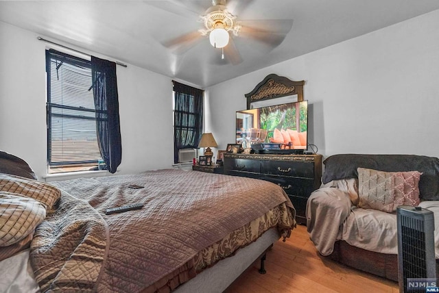 bedroom featuring hardwood / wood-style floors and ceiling fan