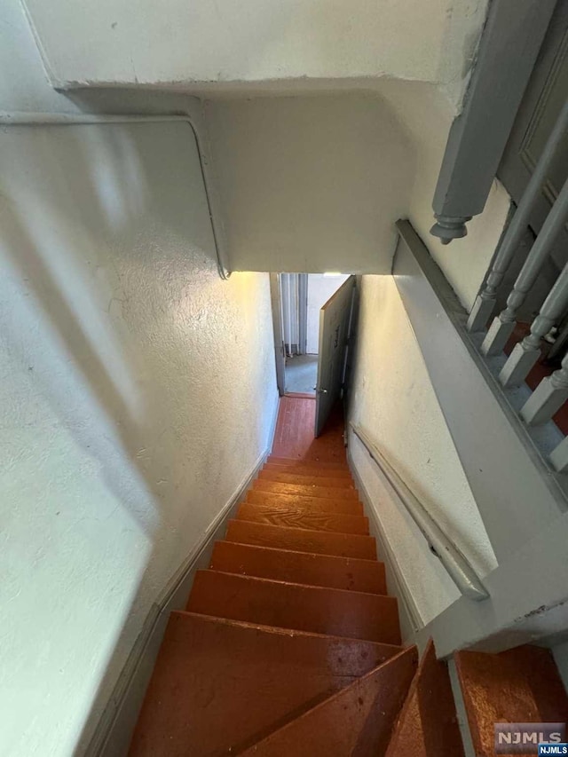 stairs featuring wood-type flooring