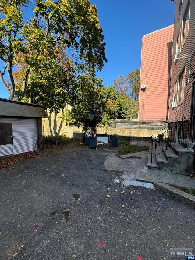 view of yard featuring a garage and an outbuilding