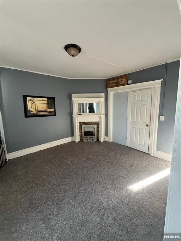 unfurnished living room featuring carpet