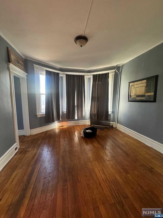 spare room with hardwood / wood-style flooring