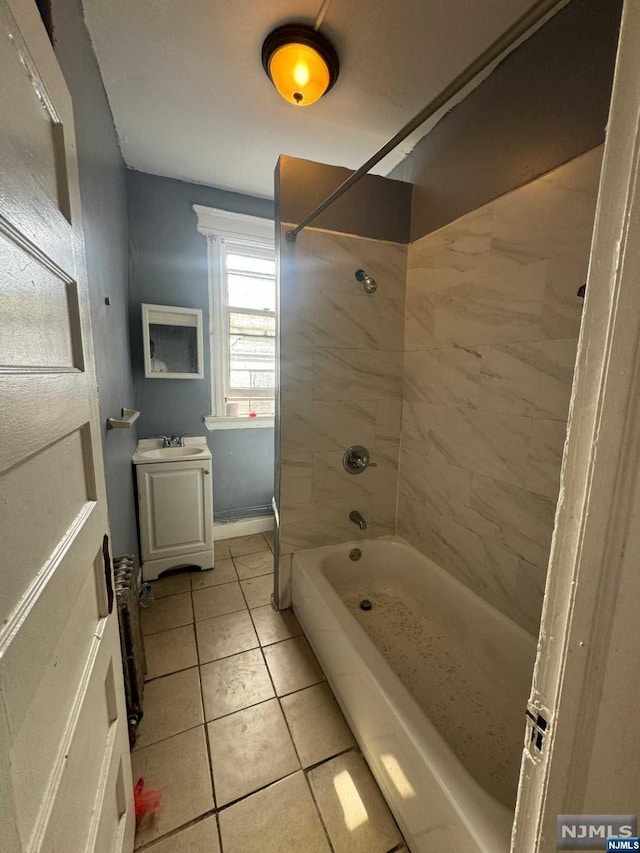 bathroom with tile patterned floors, vanity, and tiled shower / bath combo