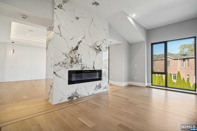 unfurnished living room featuring hardwood / wood-style floors and a fireplace