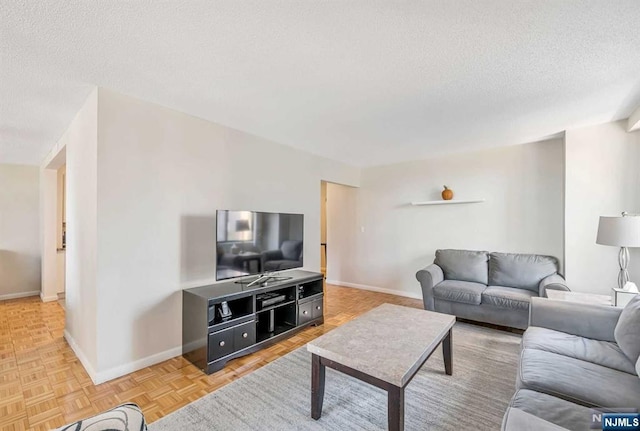 living room with a textured ceiling and parquet floors