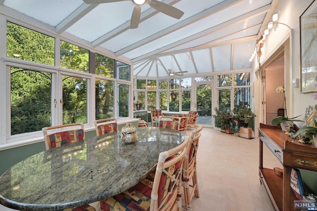 sunroom / solarium featuring lofted ceiling with beams