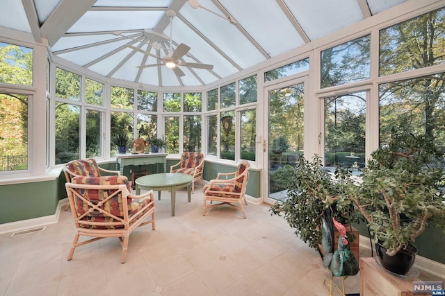 sunroom / solarium with ceiling fan and lofted ceiling