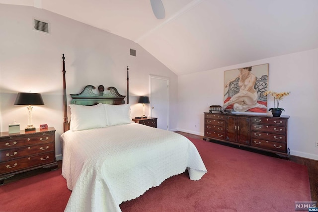 bedroom featuring dark colored carpet, vaulted ceiling, and ceiling fan