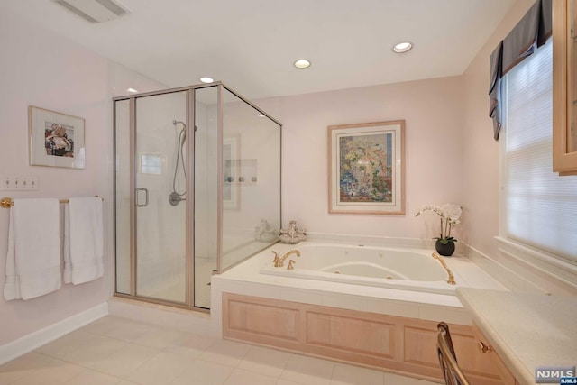 bathroom featuring tile patterned flooring and independent shower and bath