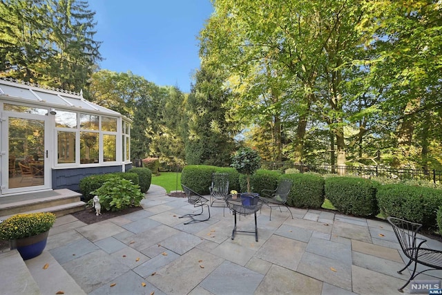 view of patio with a sunroom