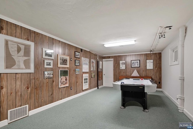 game room with carpet floors, crown molding, and wooden walls