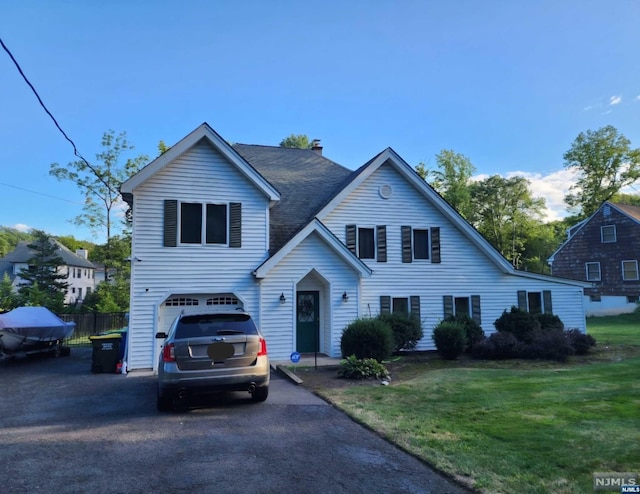 view of front of home featuring a garage and a front lawn