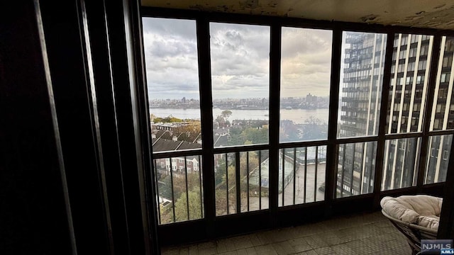 sunroom / solarium featuring a water view