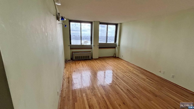 unfurnished room with light wood-type flooring