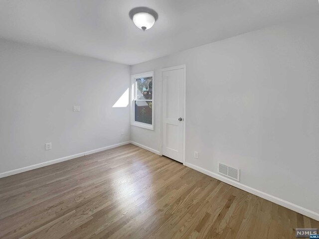 spare room featuring light hardwood / wood-style floors