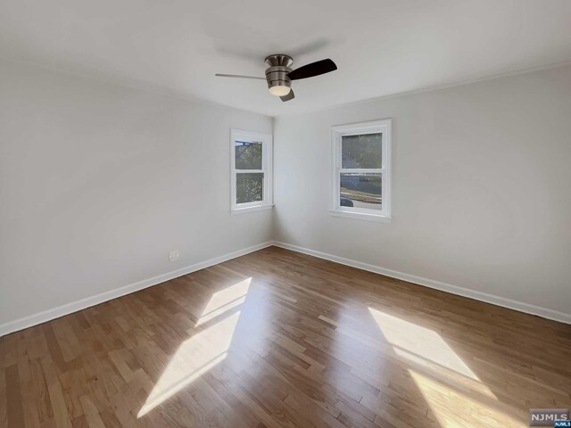 spare room featuring ceiling fan and wood-type flooring