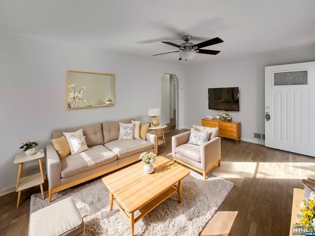 living room featuring hardwood / wood-style floors and ceiling fan