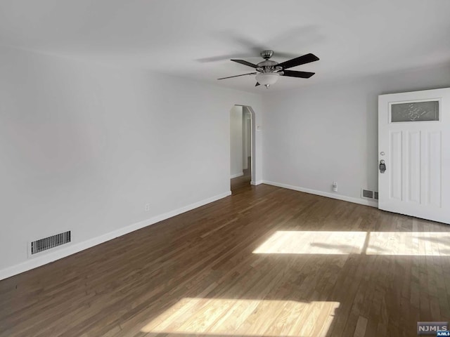 unfurnished room with ceiling fan and dark wood-type flooring