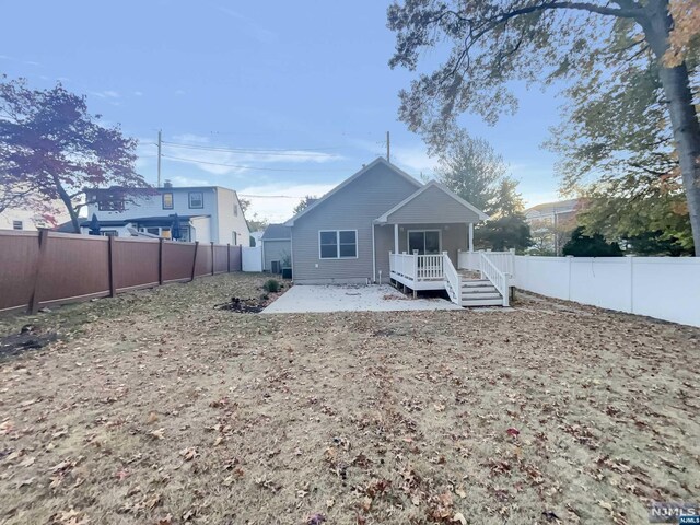 rear view of house with a deck and a patio area