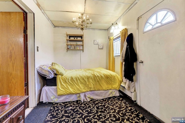 bedroom featuring carpet, a chandelier, and a baseboard radiator