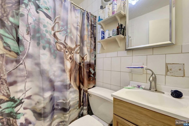 bathroom with a shower with shower curtain, backsplash, vanity, tile walls, and toilet