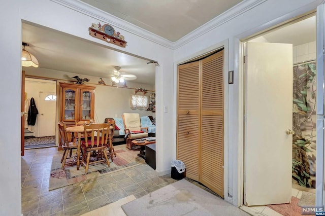 dining space featuring ceiling fan and ornamental molding