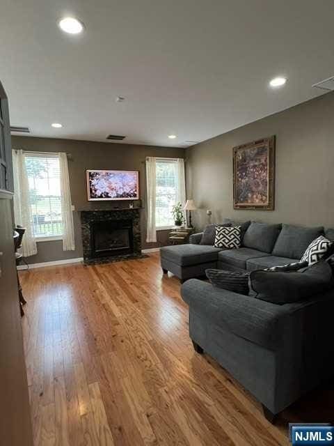 living room with hardwood / wood-style flooring and a healthy amount of sunlight