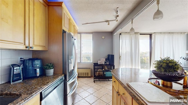 200 Winston Dr Unit 418, Cliffside Park, NJ 07010 - kitchen featuring appliances with stainless steel finishes, light tile patterned floors, a textured ceiling, backsplash, and track lighting