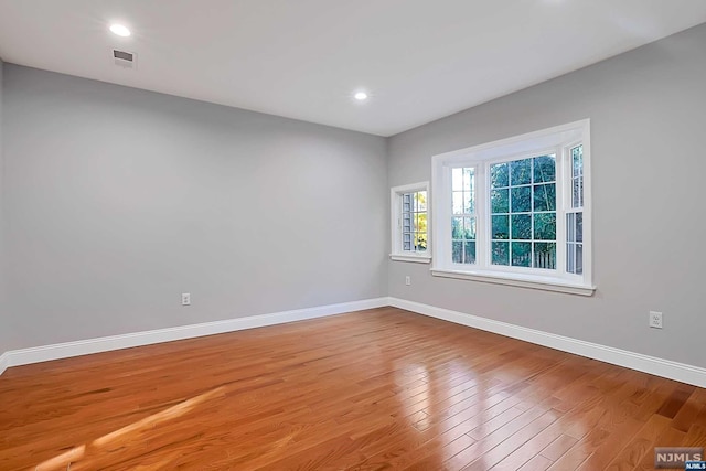 unfurnished room with light wood-type flooring