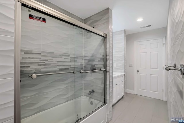 bathroom featuring vanity and enclosed tub / shower combo