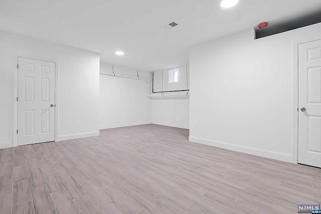 basement featuring light hardwood / wood-style floors