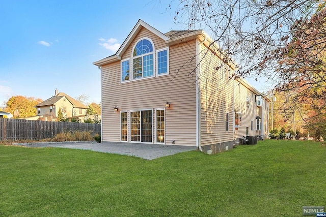 rear view of house with a patio area and a yard