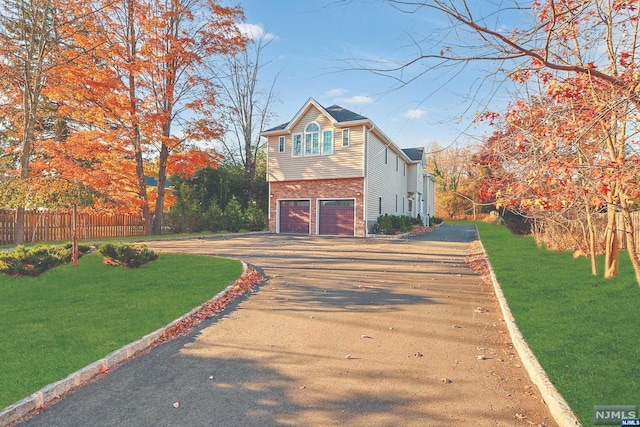 view of front of home featuring a front yard and a garage