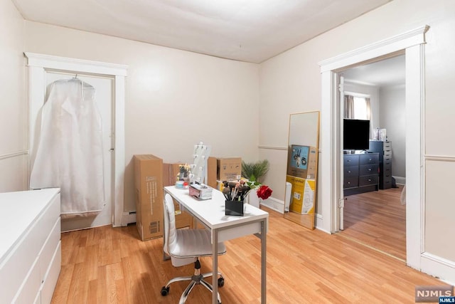 home office featuring baseboard heating and light wood-type flooring