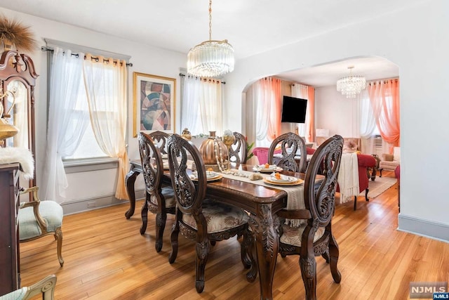 dining room with a chandelier and light hardwood / wood-style floors