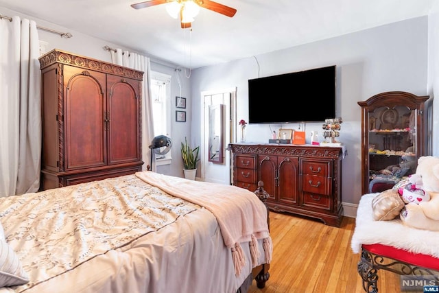 bedroom with ceiling fan and light wood-type flooring