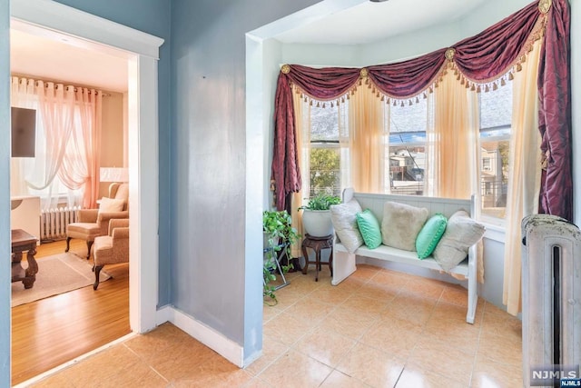 sitting room with hardwood / wood-style floors and radiator