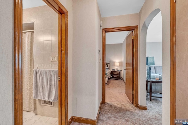 hallway with light colored carpet