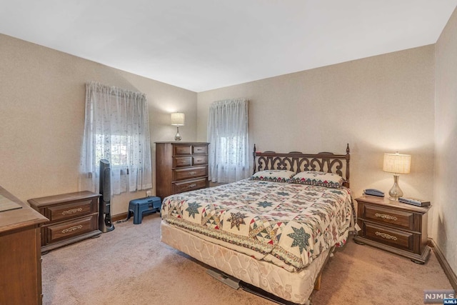 bedroom featuring light colored carpet