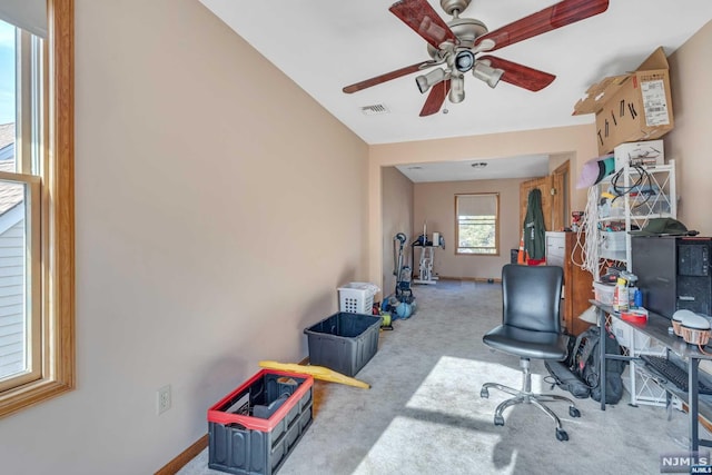 office space with light carpet and ceiling fan