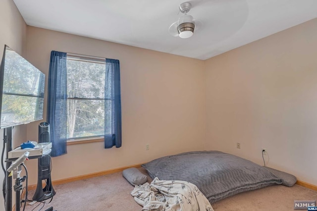 bedroom with light carpet and ceiling fan